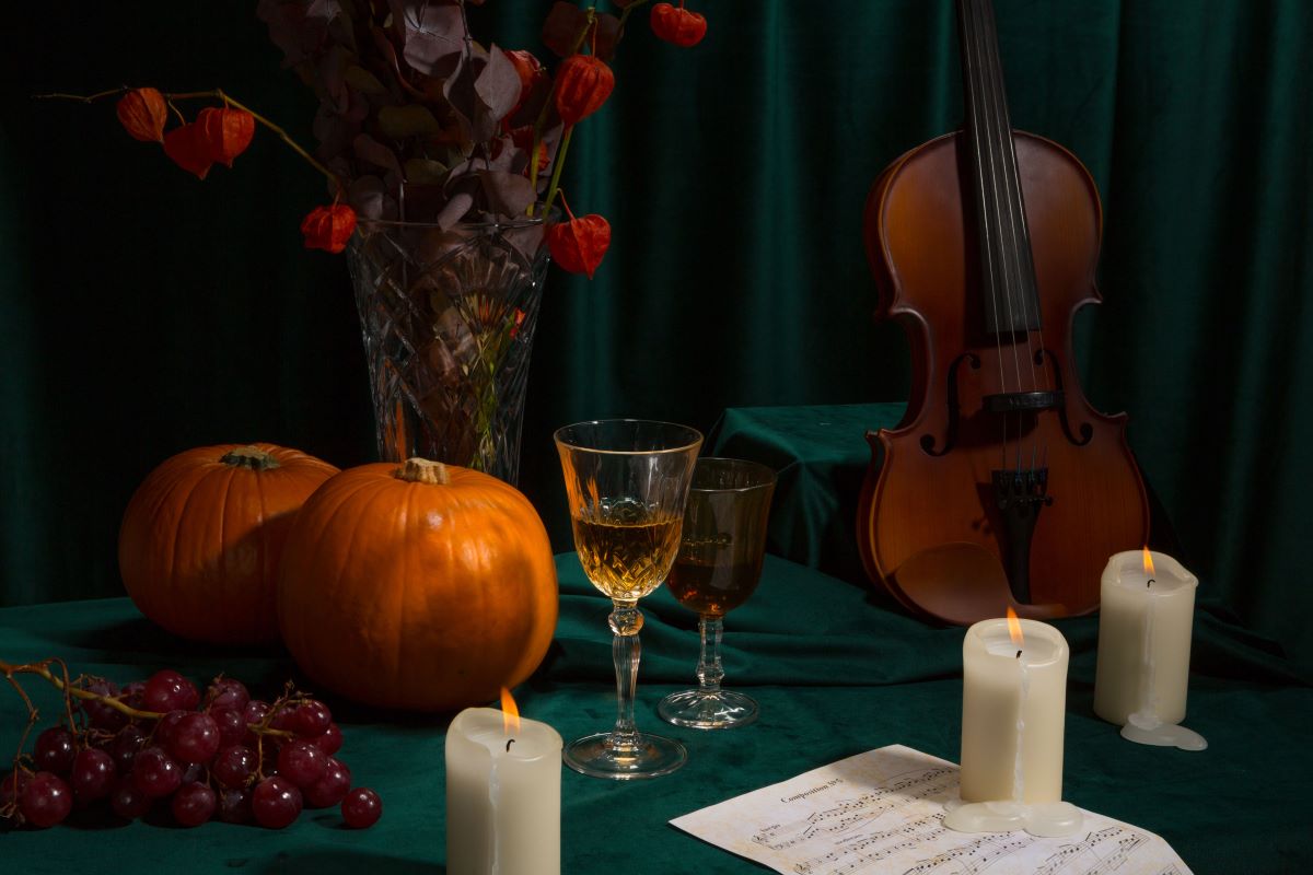 A pumpkin, candles, violin, and more on display for Candlelight Halloween. 