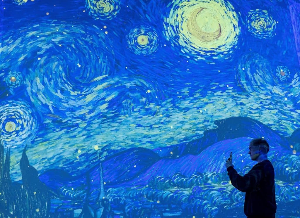 silhouette pf person taking a photo at Van Gogh: The Immersive Experience soon opening in Singapore