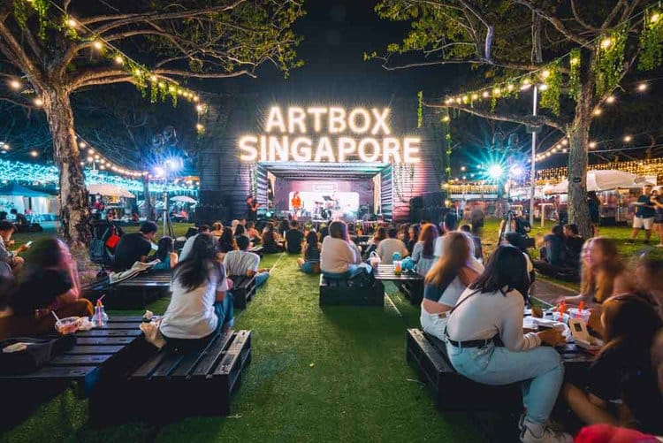 people sitting from front of artbox makeshift stage in singapore