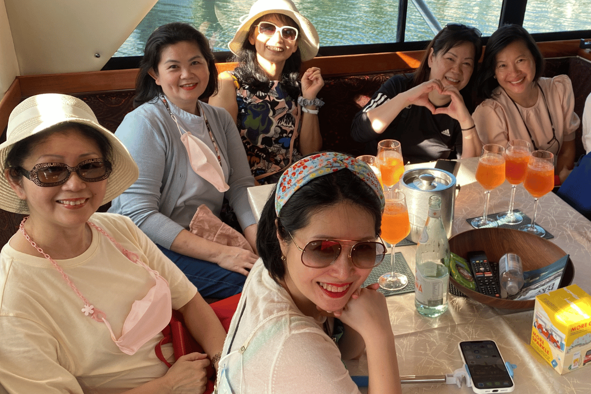 Women enjoying a dinner onboard a yacht in singapore