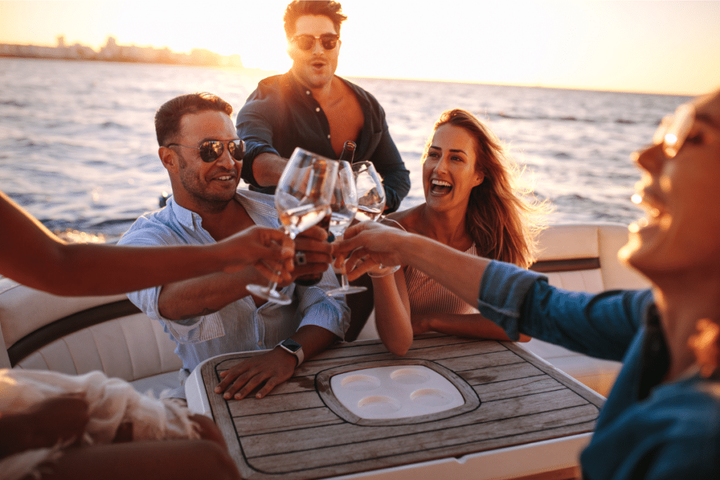 people drinking wine at sunset on a yacht